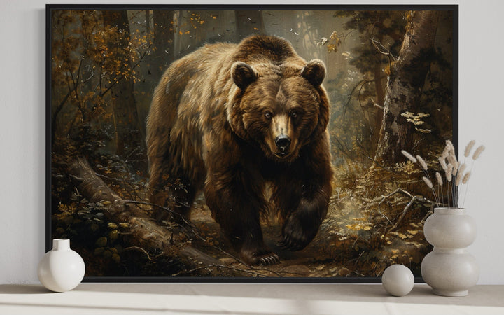 Framed canvas wall art of a brown bear walking through a vintage-style forest for cabin decor.