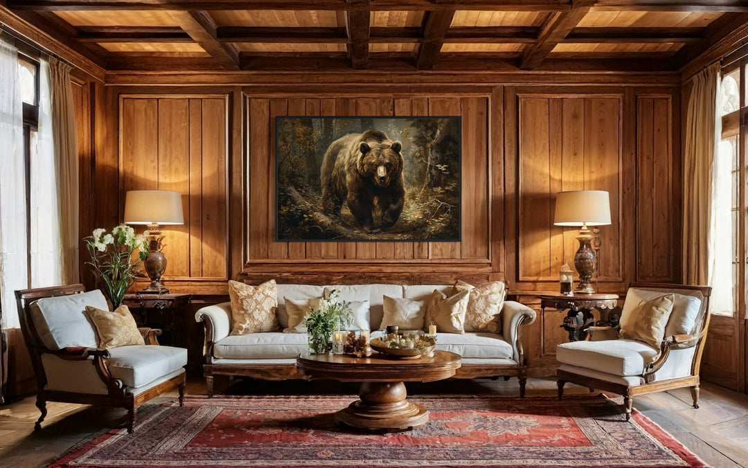 Bear in the forest framed canvas wall art hanging above a sofa in a rustic wood-paneled living room.