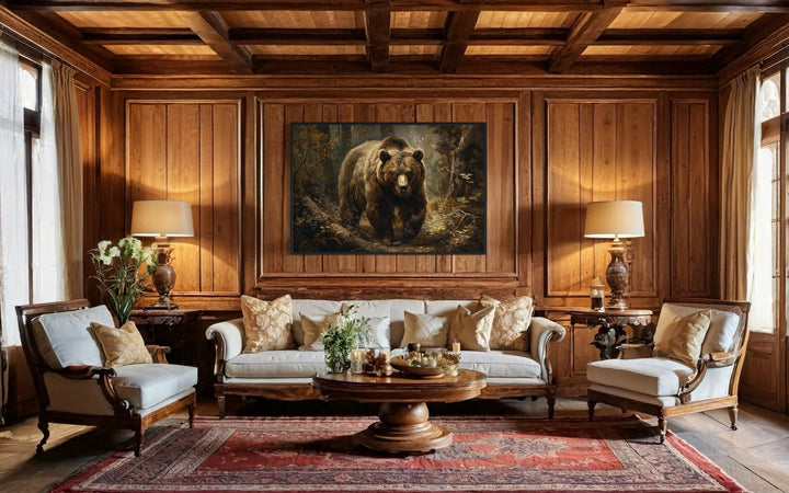 Bear in the forest framed canvas wall art hanging above a sofa in a rustic wood-paneled living room.