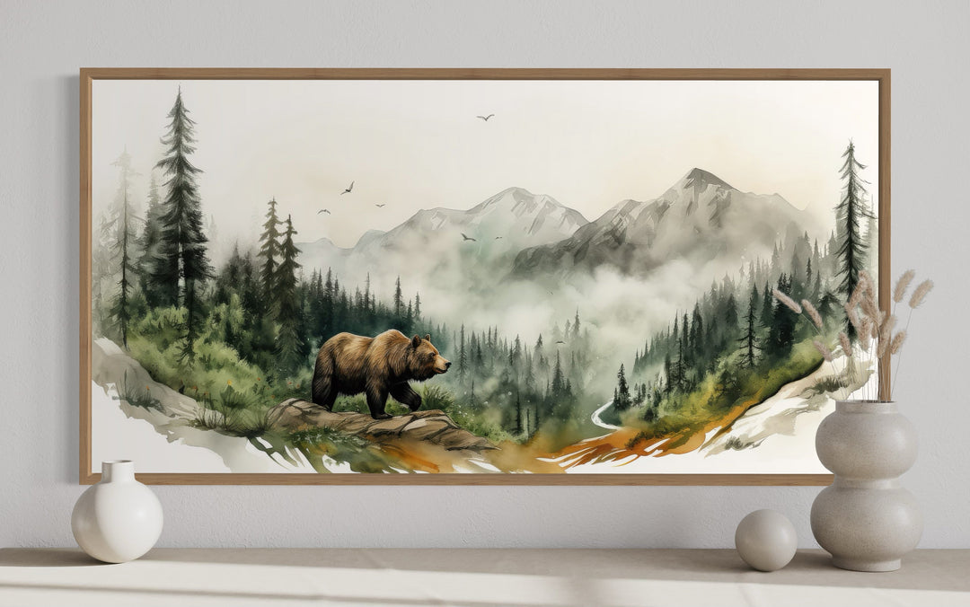 Watercolor bear in a misty mountain forest landscape wall art in a wooden frame.