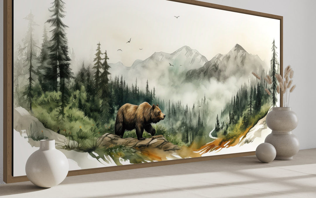 Watercolor wall art of a bear in a misty mountain forest with rustic cabin wildlife decor.