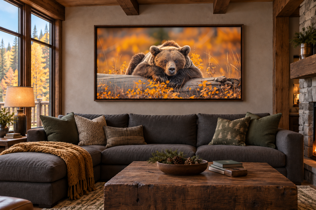 Framed grizzly bear on a log wall art in a rustic living room with autumn forest colors.