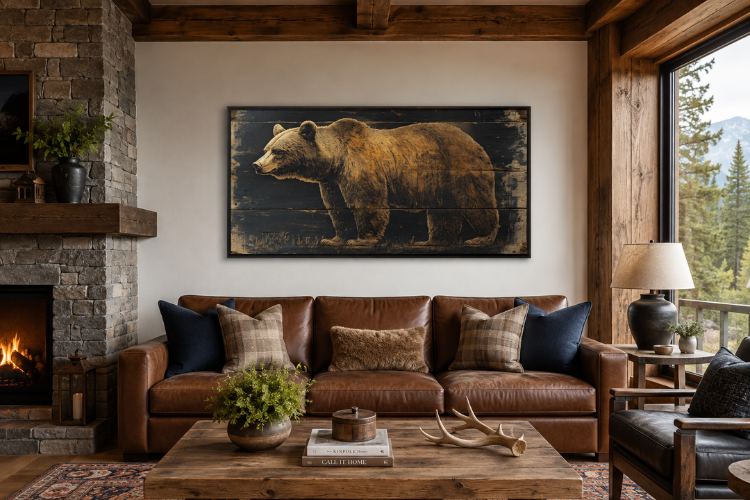 Bear painted on dark wood framed canvas wall art hanging above a brown leather sofa in a cabin.
