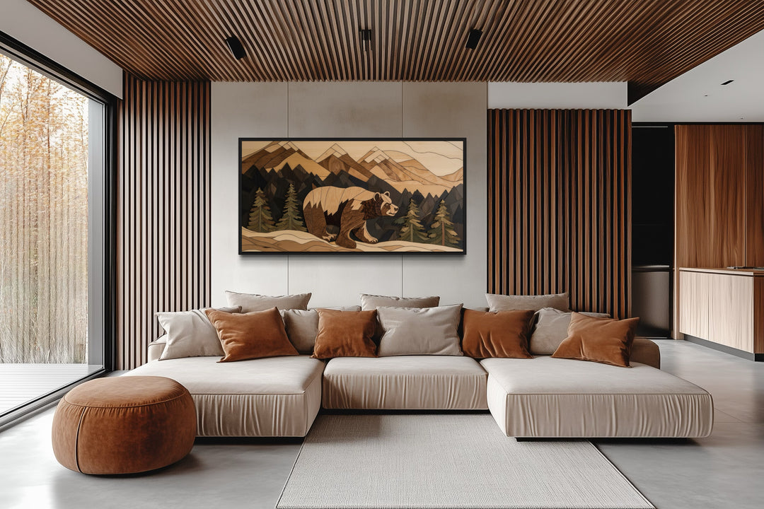 Bear painting on wood canvas wall art in a rustic mountain landscape above a modern sofa.