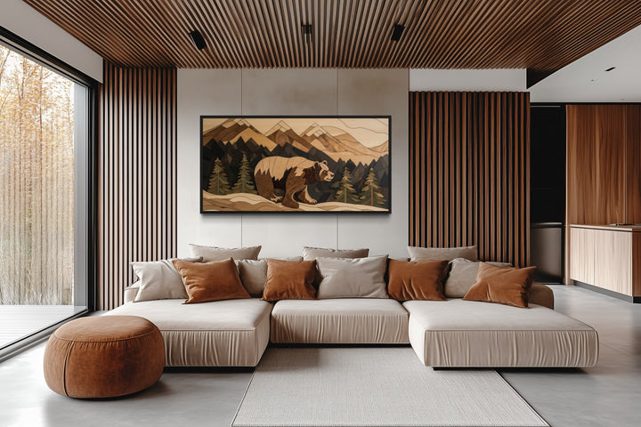 Bear painting on wood canvas wall art in a rustic mountain landscape above a modern sofa.