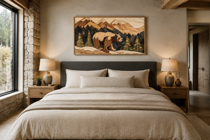 Rustic bear and mountain landscape wood panel wall art hanging above a bed in a cabin-style room.
