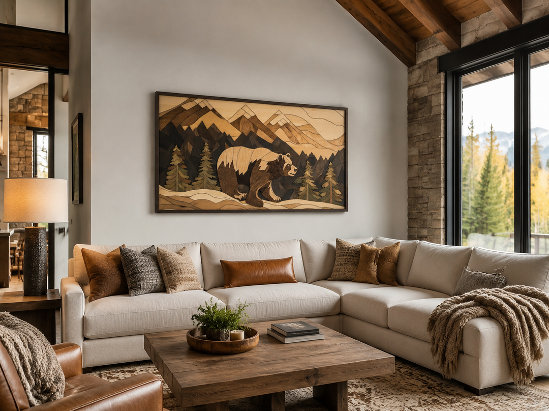 Rustic bear and mountain landscape wood panel wall art above a cream sectional sofa in a cabin.