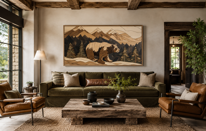 Rustic bear and mountain landscape wood panel wall art above a green sofa in a cabin living room.