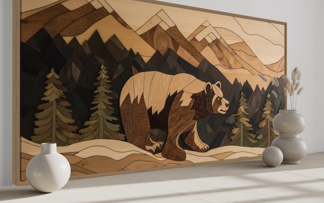 Rustic wood panel wall art of a bear in a mountain landscape with pine trees and earthy tones.