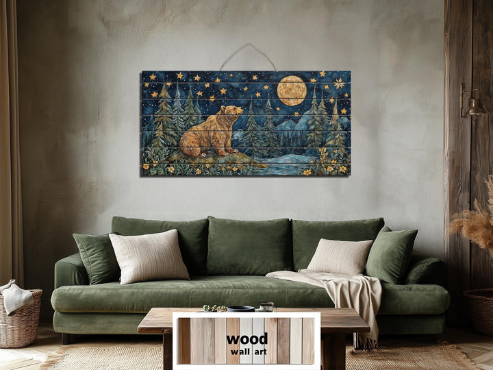 Rustic wood wall art featuring a bear under a full moon and stars above a green sofa.