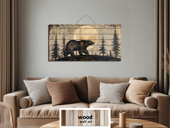 Rustic bear and moon forest scene printed on horizontal distressed wood planks above a tan sofa.