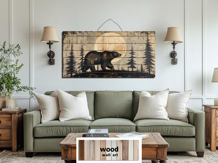 Rustic bear and forest scene printed on horizontal distressed wood planks above a green sofa.
