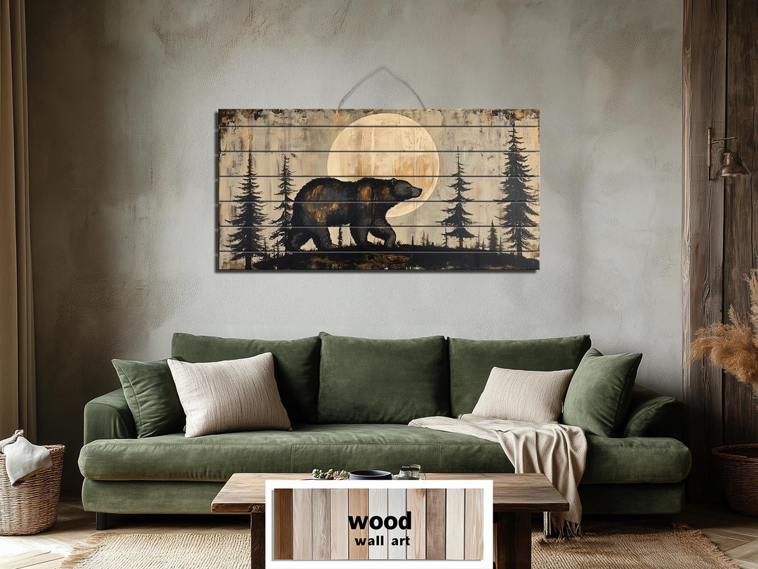 Rustic bear and moon forest scene printed on horizontal distressed wood planks above a green sofa.
