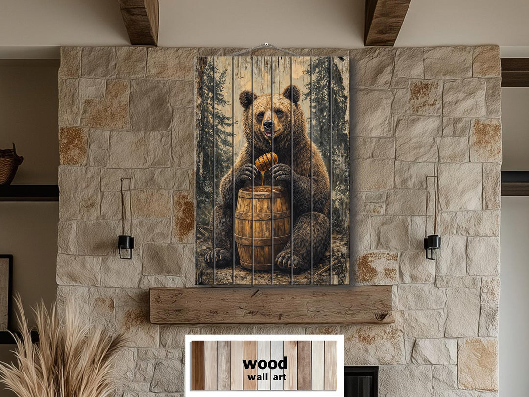 Bear with honey barrel distressed wood wall art hanging on a stone fireplace in a rustic cabin.