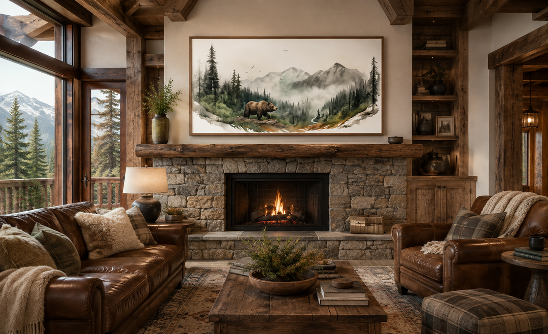 Framed watercolor painting of a bear in a mountain forest above a rustic stone fireplace.