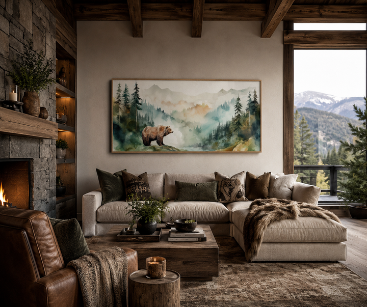 Watercolor framed canvas wall art of a bear in a misty mountain forest above a rustic living room.
