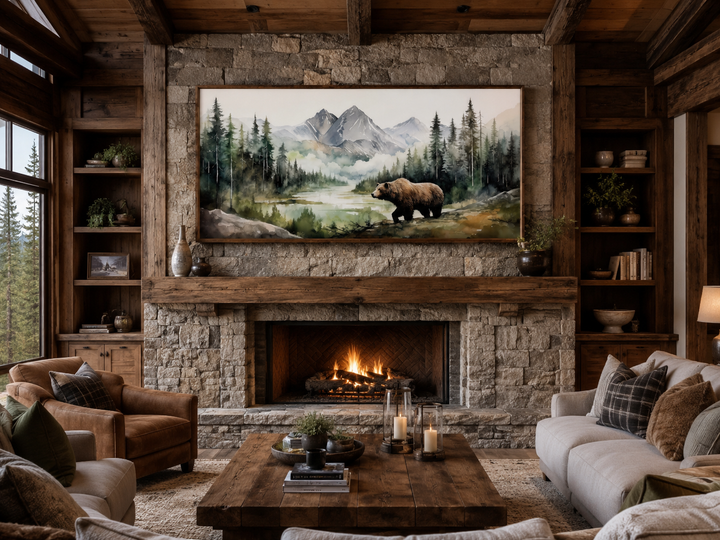 Large watercolor painting of a bear in a mountain forest, hung above a rustic stone fireplace.