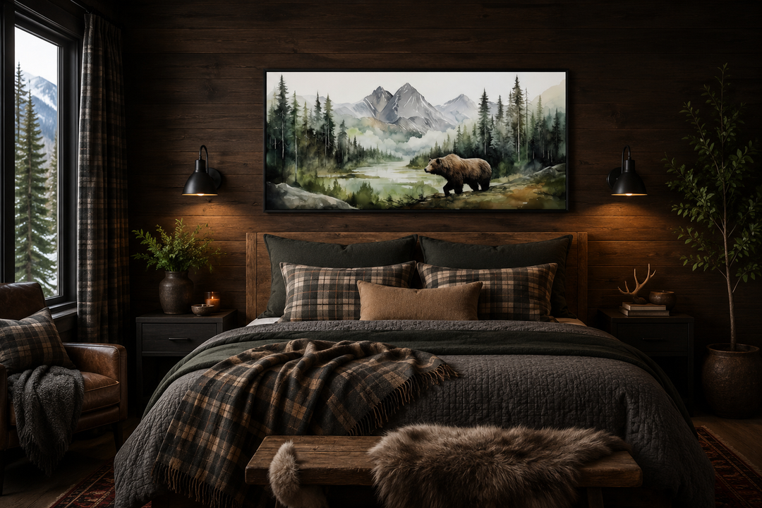 Large watercolor canvas of a bear in a mountain forest hanging above a bed in a rustic cabin.