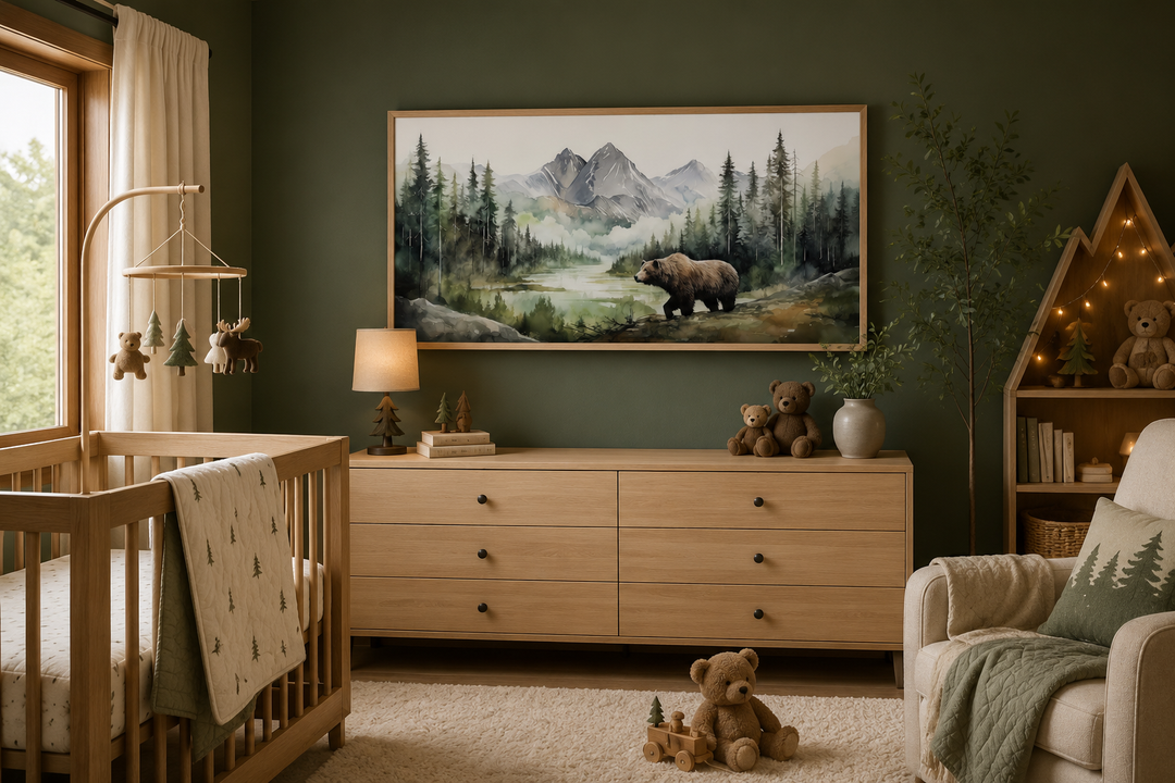 Large framed watercolor painting of a bear in a mountain forest above a nursery dresser.