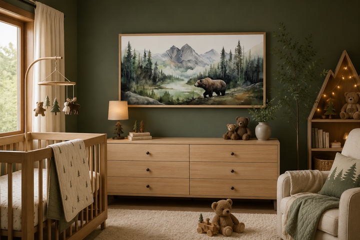 Large framed watercolor painting of a bear in a mountain forest above a nursery dresser.