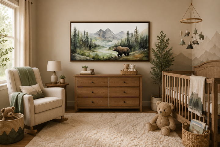 Large framed watercolor painting of a bear in a mountain forest, hung in a rustic nursery.