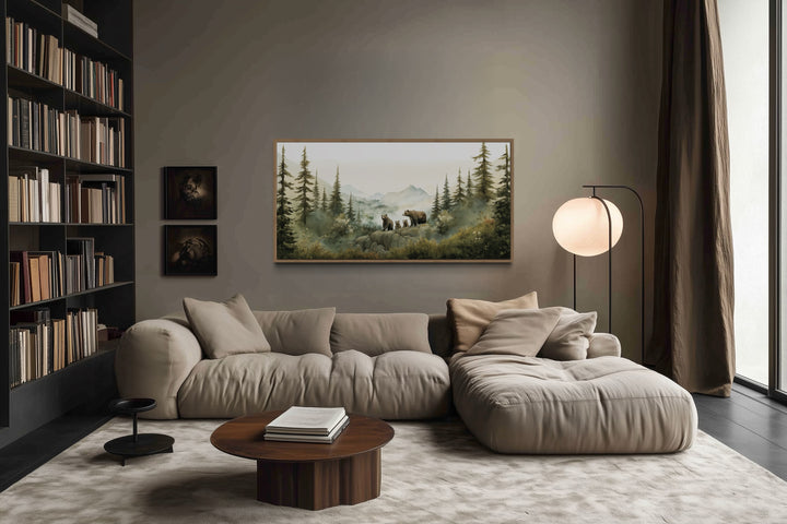 Bears family with cubs in a forest watercolor nursery wall art framed above a beige sofa.