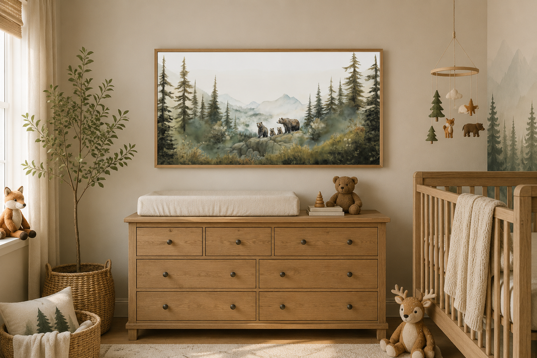 Watercolor wall art of a bear family in a forest, framed above a wooden dresser in a nursery.
