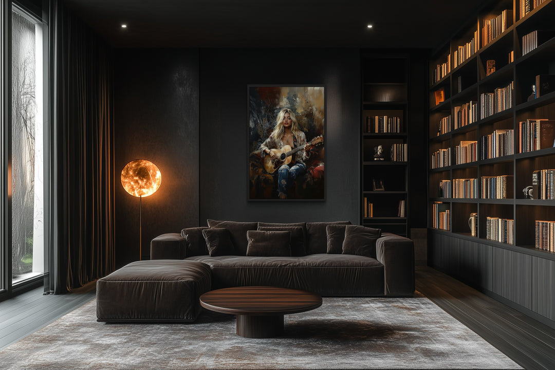 Framed canvas wall art of a blonde girl playing guitar in a dark, modern living room with a library.