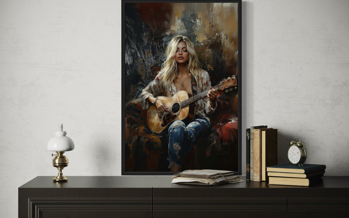 Framed canvas wall art of a blonde girl playing an acoustic guitar in an impressionist style.