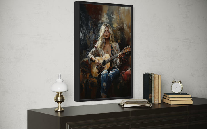 Framed canvas wall art of a blonde girl playing guitar, displayed above a dark wooden dresser.