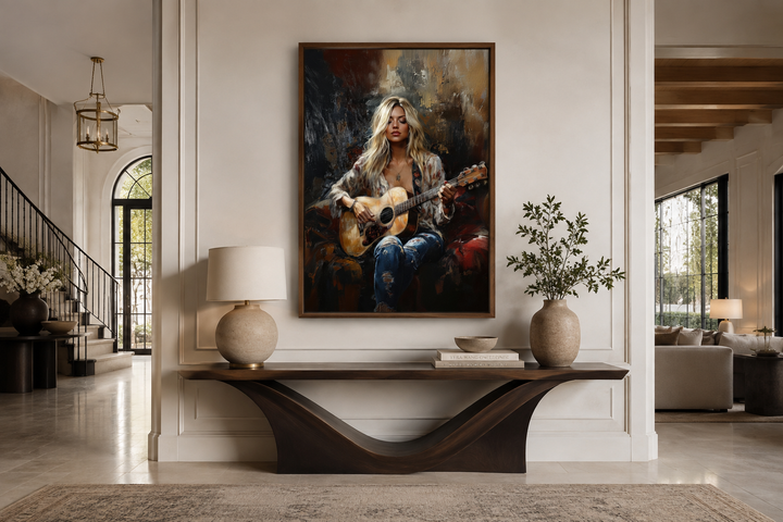 Framed canvas art of a blonde girl playing guitar, hung above a console table in a modern room.