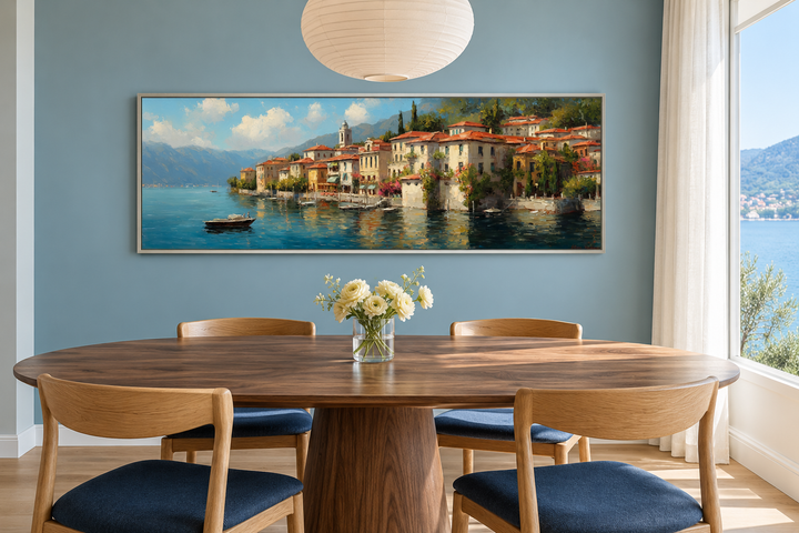 Bellagio Lake Como framed canvas wall art above a dining table with blue chairs and white flowers.