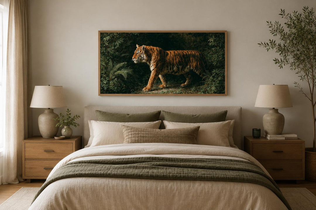 Bengal tiger canvas print in a wide frame hanging above a bed in a neutral-toned bedroom.