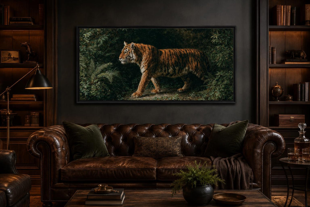 Bengal tiger canvas print in a cinematic format above a brown leather sofa in a dark study.