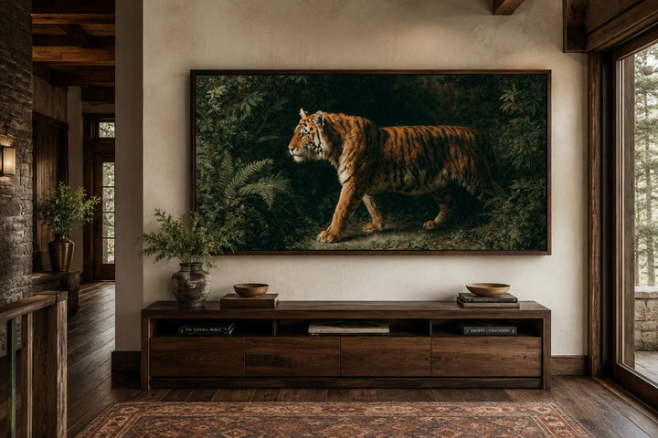 Bengal tiger canvas print in a dark wood frame above a console table in a rustic living room.