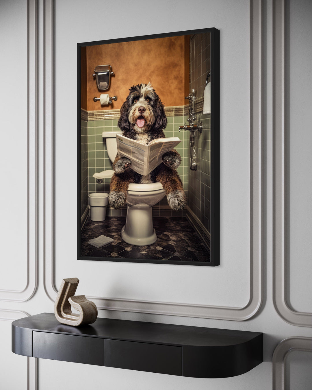 Framed canvas wall art of a Bernedoodle dog sitting on a toilet reading a newspaper in a bathroom.
