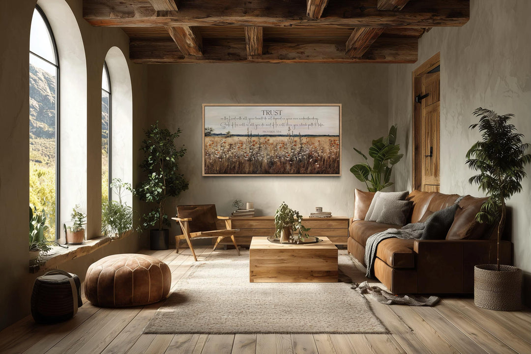 Bible Verse Wall Art featuring Proverbs 3:5 over a golden wildflower field in a rustic living room.