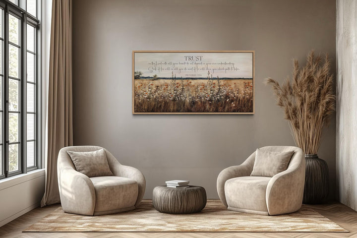 Bible Verse wall art featuring Proverbs 3:5 over a golden wildflower field in a neutral room.