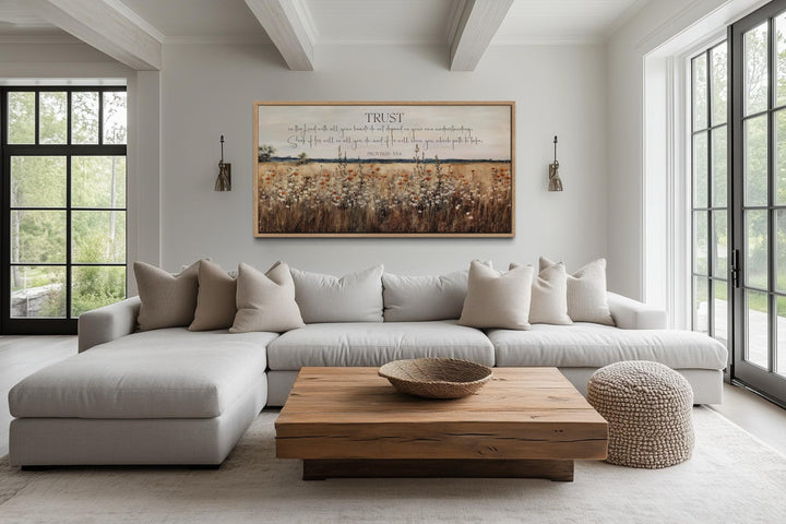 Horizontal canvas art with Proverbs 3:5 scripture over a golden wildflower field in a modern room.