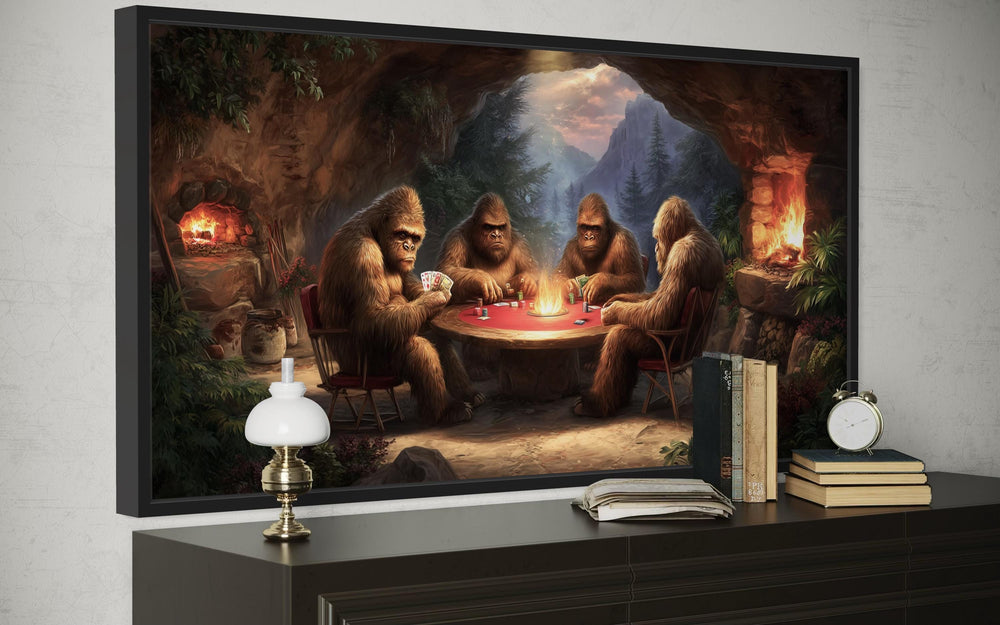 Bigfoot playing poker canvas wall art in a cave setting, displayed above a dark wooden console.