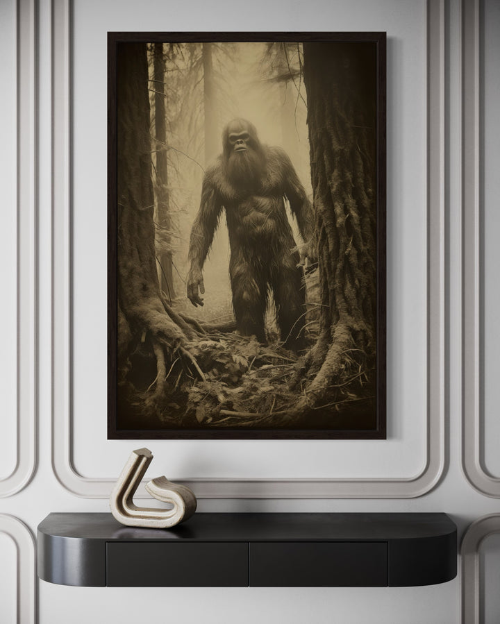 Bigfoot realistic photograph framed canvas wall art hanging above a black console table.