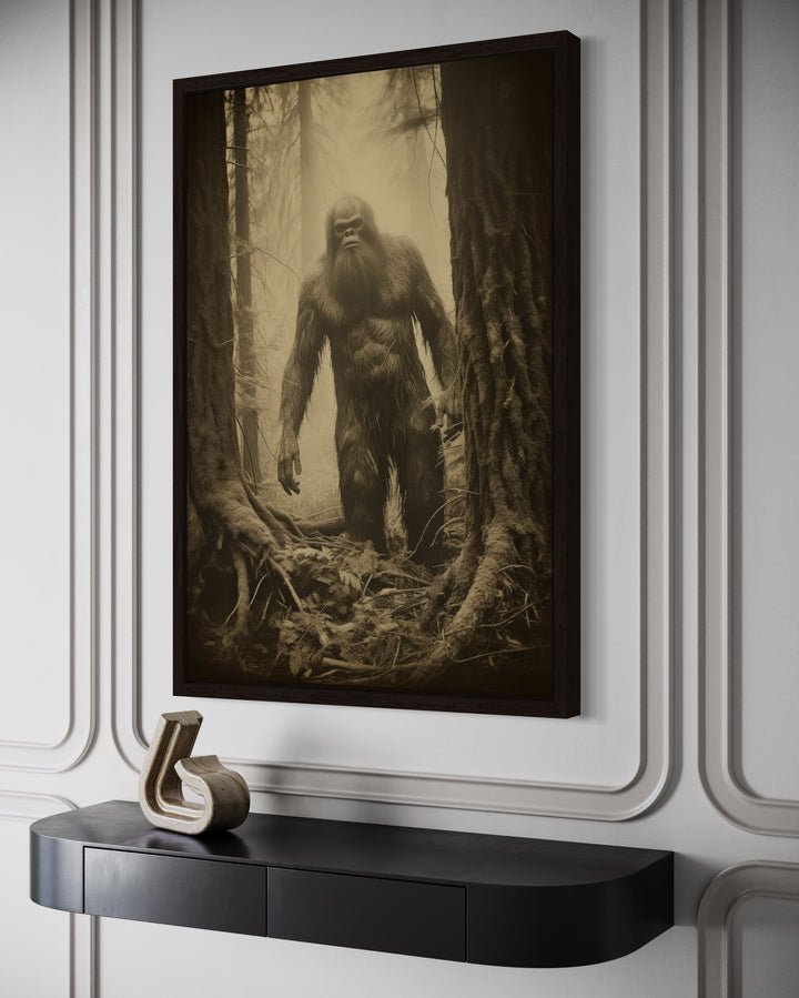 Bigfoot realistic photograph framed canvas wall art in a misty forest, hanging above a black console.