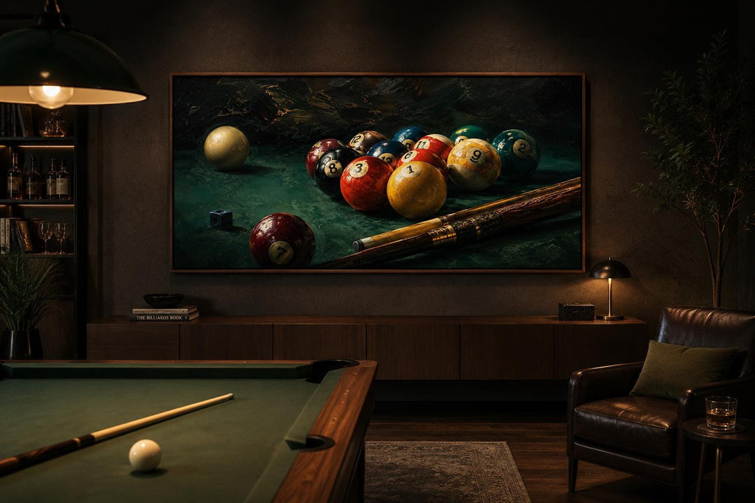 Billiard balls canvas print on a dark wall above a sideboard in a moody game room with pool table.