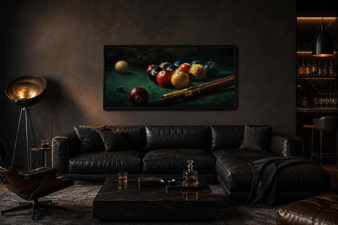 Billiard balls canvas print above a black leather sofa in a dark, modern living room.