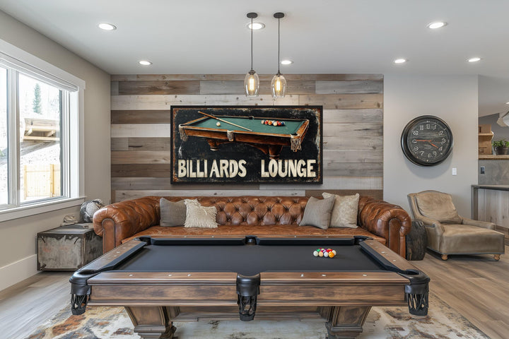 Billiards Lounge canvas print hanging above a leather sofa in a game room with a pool table.
