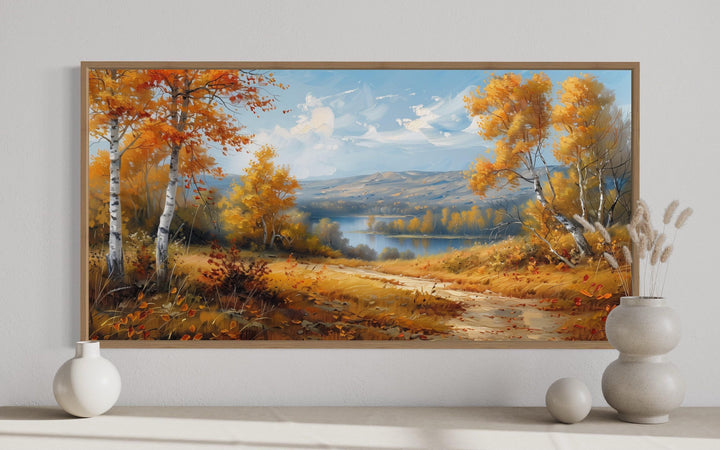 Framed canvas wall art of a bright autumn birch forest landscape with a river and distant hills.
