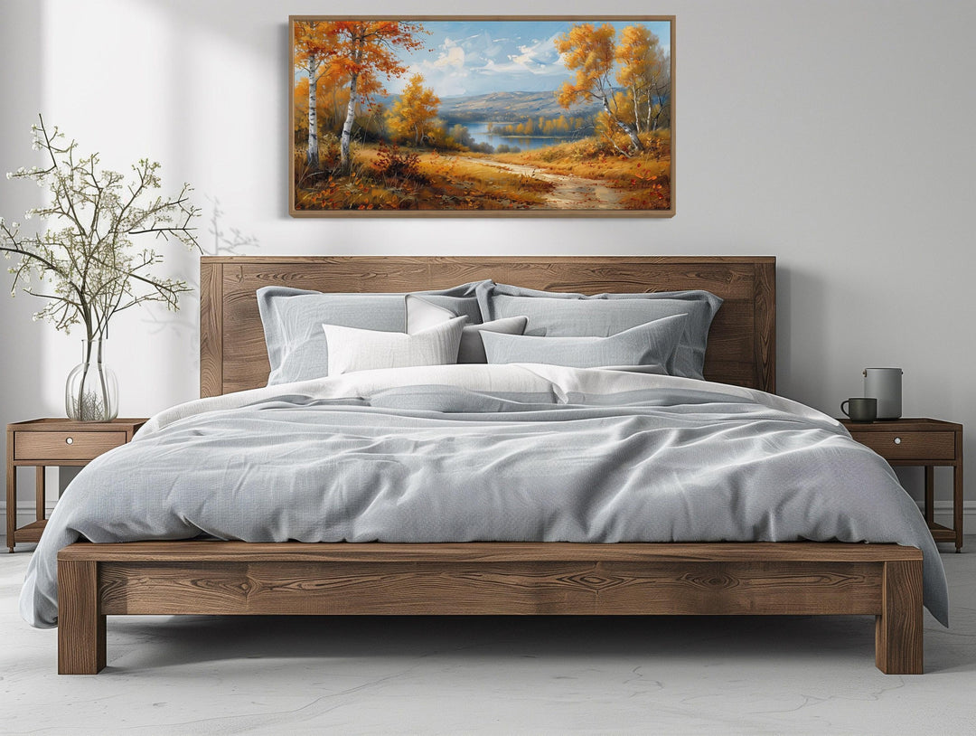 Birch Trees Forest And River In Autumn Framed Canvas Wall Art above a wooden bed frame.
