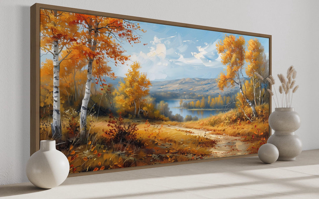 Framed canvas wall art of a golden autumn birch forest landscape with a river and distant mountains.