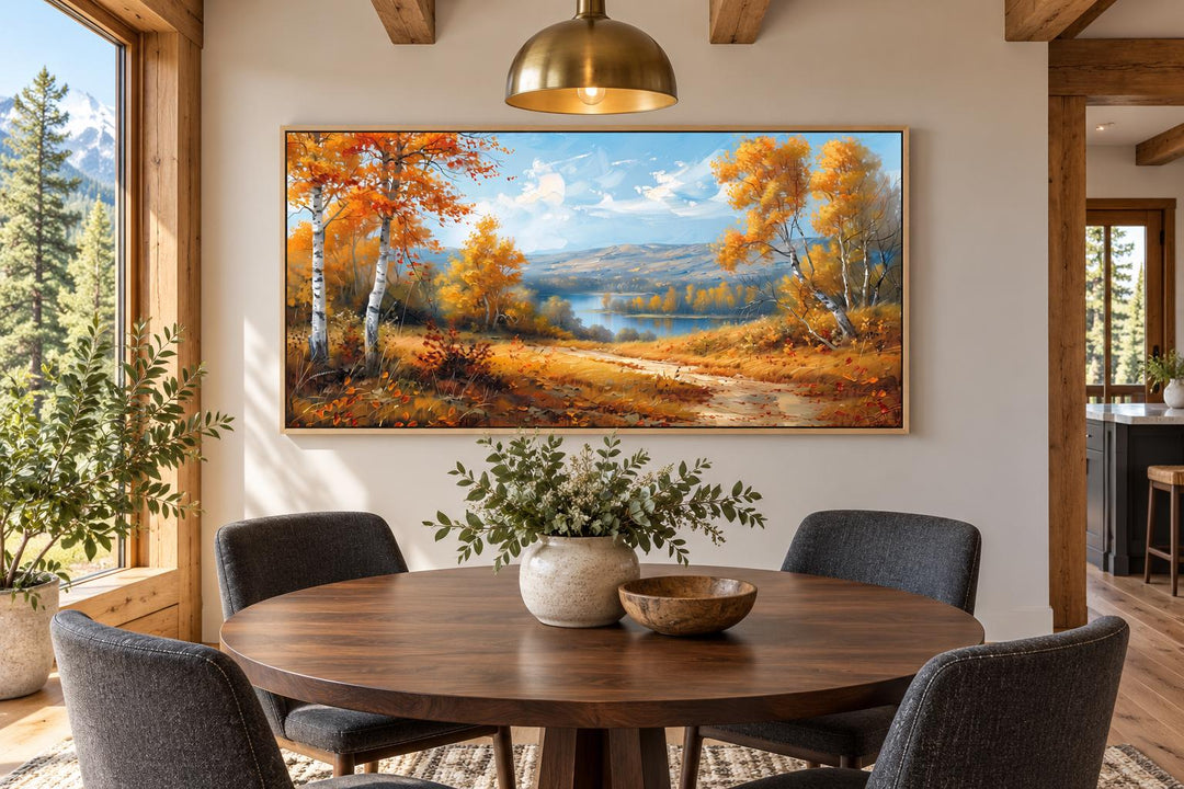 Birch Trees Forest and River in Autumn framed canvas wall art above a wooden dining table.