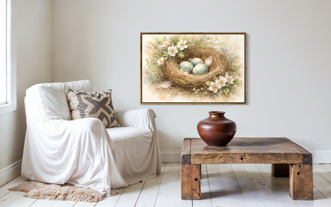 Bird nest wall art featuring blue eggs and spring florals in a rustic living room setting.